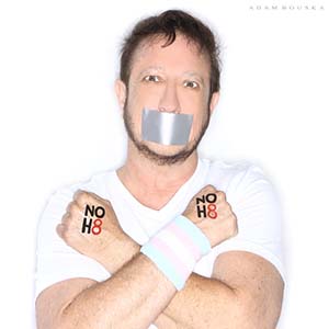 Transgender man posing with duck tape over mouth and