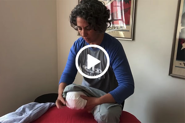 Massage therapist demonstrating how to make a