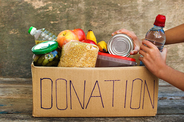 A box of canned goods and food labeled 
